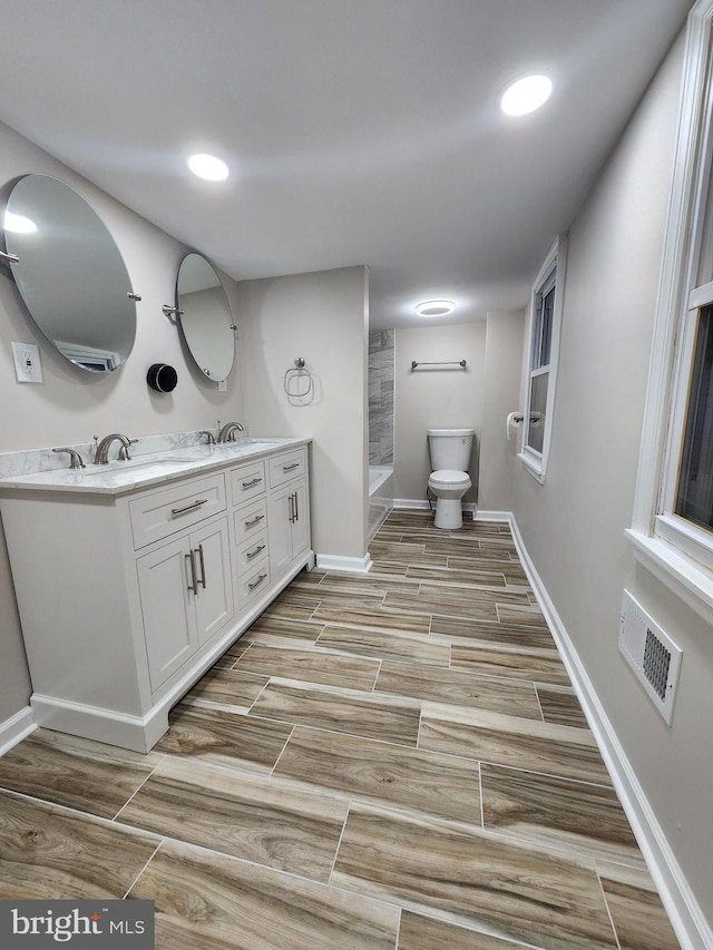 bathroom featuring vanity and toilet