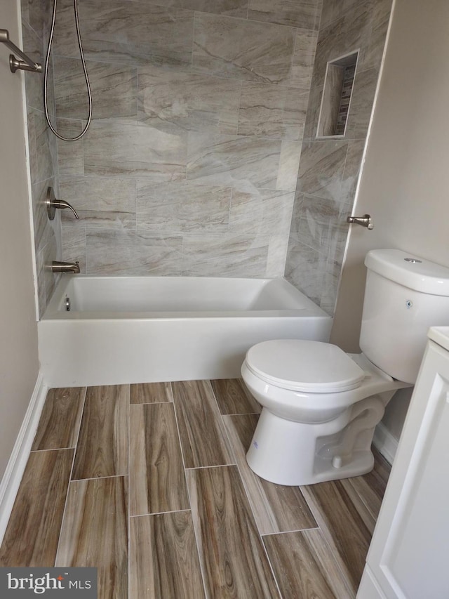 full bathroom with vanity, toilet, and tiled shower / bath combo