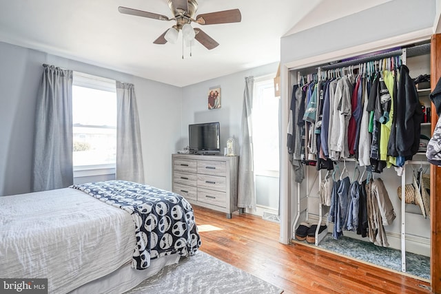 bedroom with a closet, visible vents, ceiling fan, and light wood-style flooring