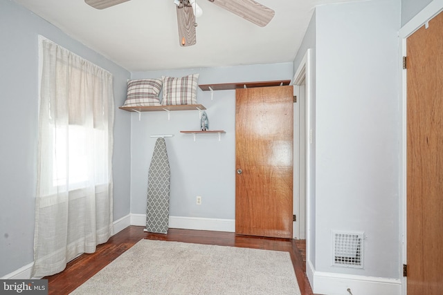 interior space featuring dark wood-style floors, visible vents, and a ceiling fan