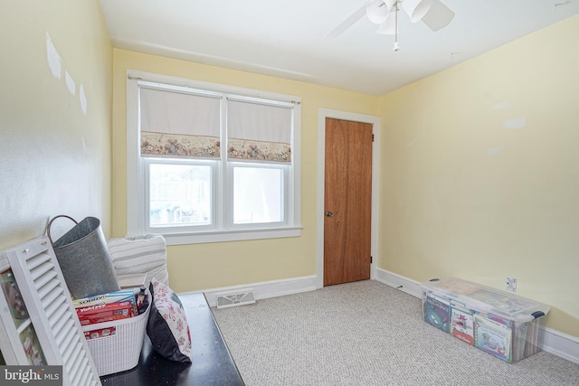 interior space featuring baseboards, visible vents, and ceiling fan