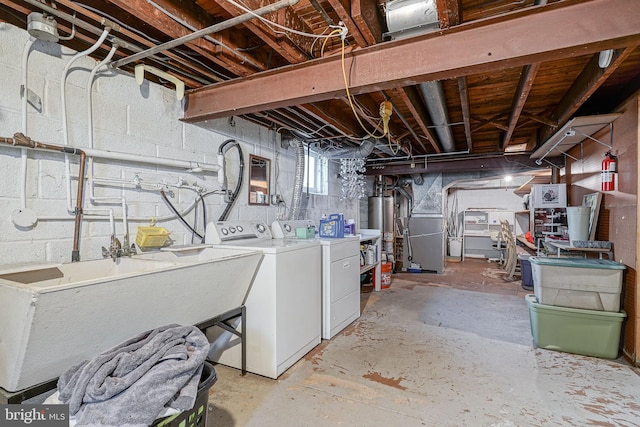 below grade area with heating unit, water heater, separate washer and dryer, and a sink