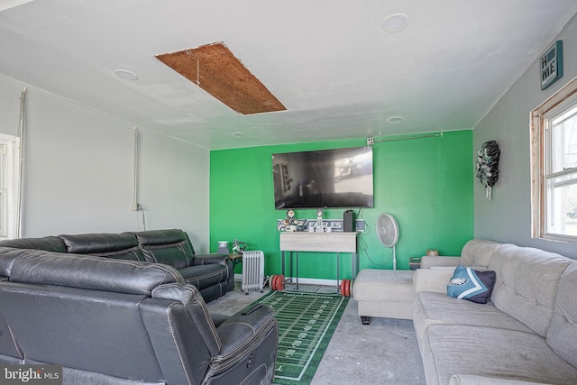 living room featuring radiator and baseboards