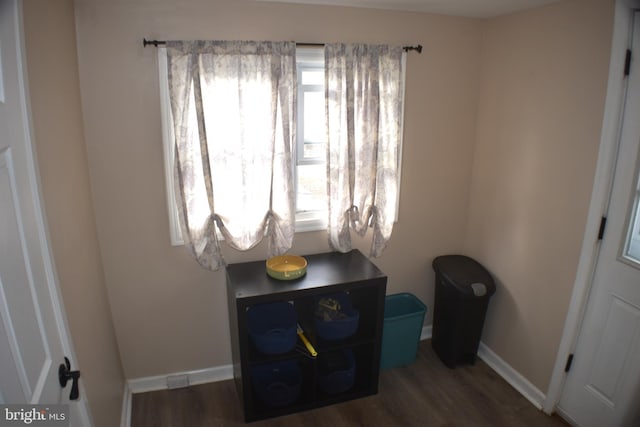 bedroom featuring baseboards and wood finished floors