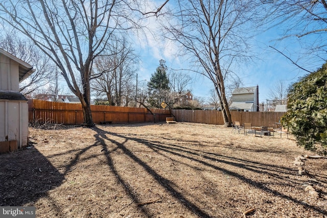 view of yard with an outdoor fire pit and a fenced backyard