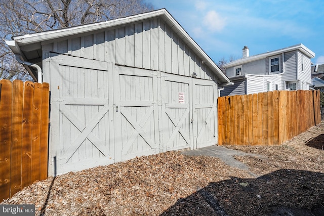 view of outdoor structure with an outbuilding and fence