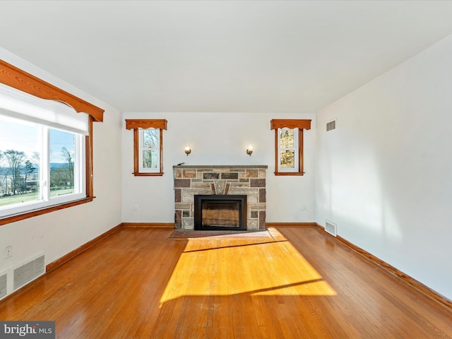 unfurnished living room with light wood-type flooring and a fireplace