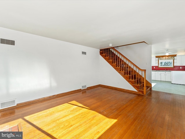 unfurnished living room with wood-type flooring