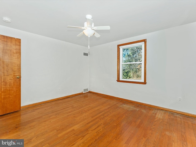 empty room featuring ceiling fan and wood-type flooring