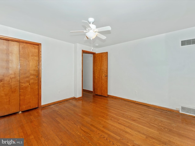 unfurnished bedroom featuring light hardwood / wood-style floors, a closet, and ceiling fan