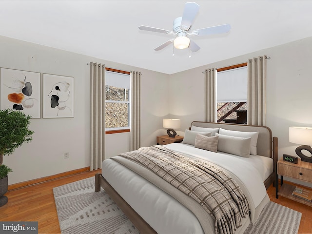 bedroom with light hardwood / wood-style flooring and ceiling fan