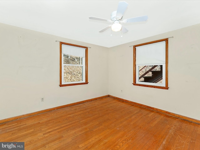 spare room with ceiling fan and wood-type flooring