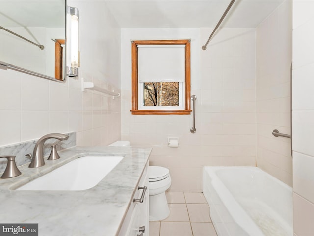 full bathroom featuring tile walls, vanity, toilet, and tile patterned floors