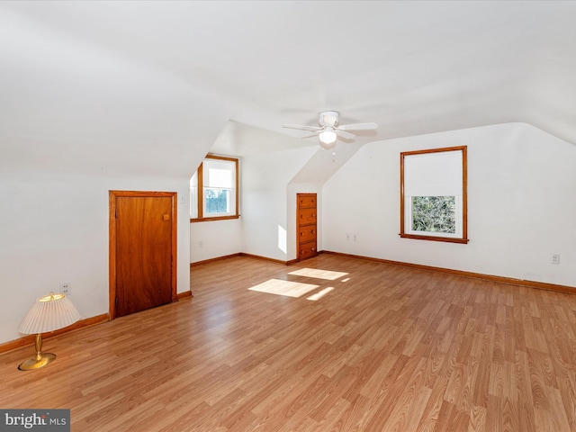 additional living space featuring light wood-type flooring, vaulted ceiling, and ceiling fan