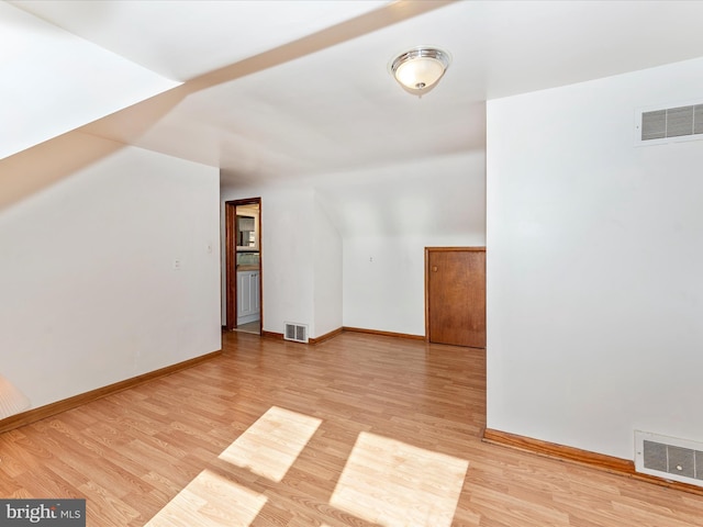 additional living space featuring light hardwood / wood-style floors