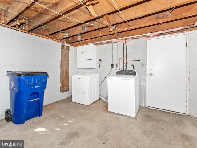 basement with refrigerator and washer and clothes dryer