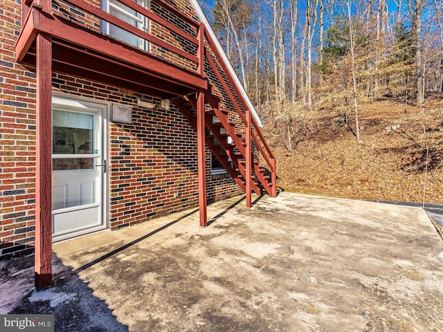 view of side of home with a patio