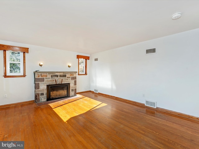 unfurnished living room with hardwood / wood-style flooring and a fireplace