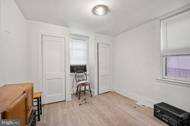 office space with cooling unit and light hardwood / wood-style floors