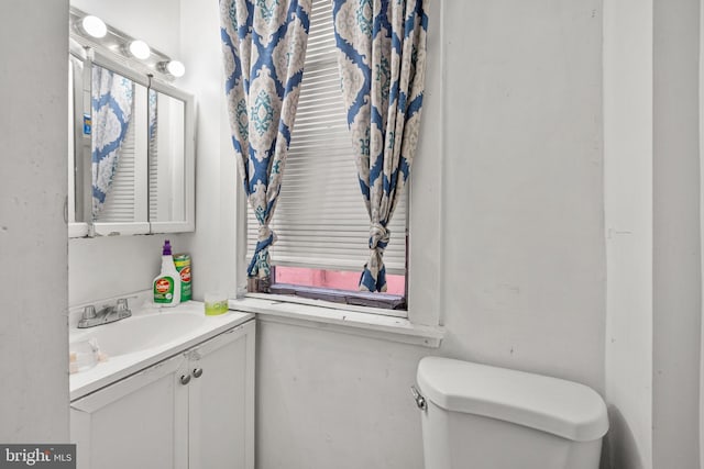 bathroom featuring vanity and toilet