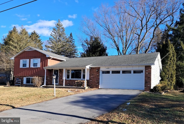 tri-level home with a garage and a front lawn