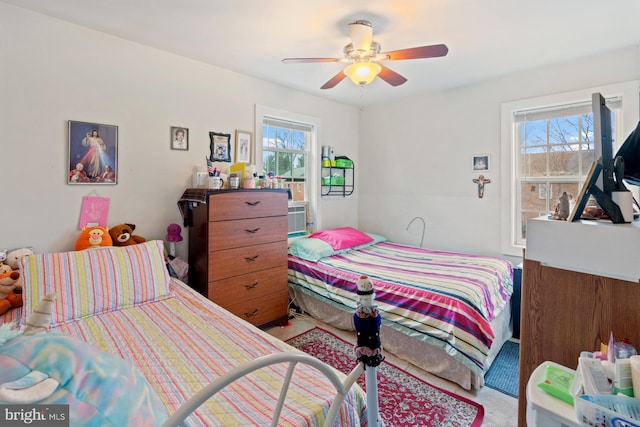 bedroom featuring multiple windows and ceiling fan