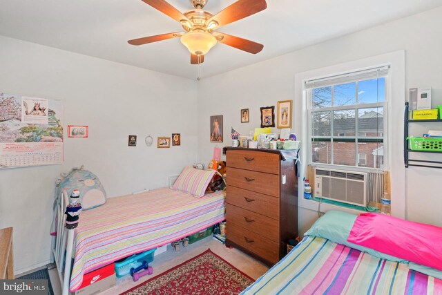 bedroom featuring cooling unit and ceiling fan