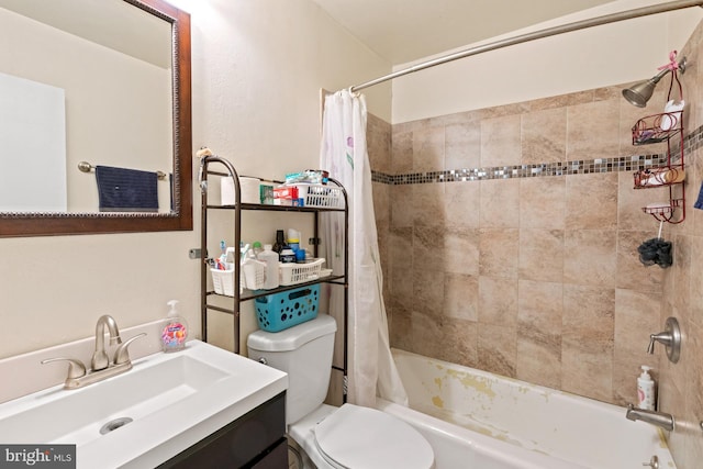 full bathroom with vanity, shower / tub combo with curtain, and toilet