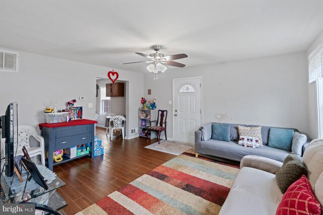 living room featuring plenty of natural light, dark hardwood / wood-style floors, and ceiling fan