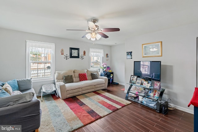 living room with dark wood-type flooring and ceiling fan