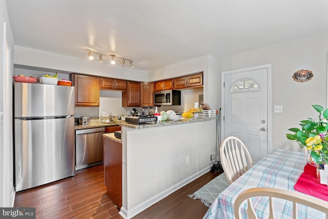 kitchen with stainless steel appliances and light stone countertops