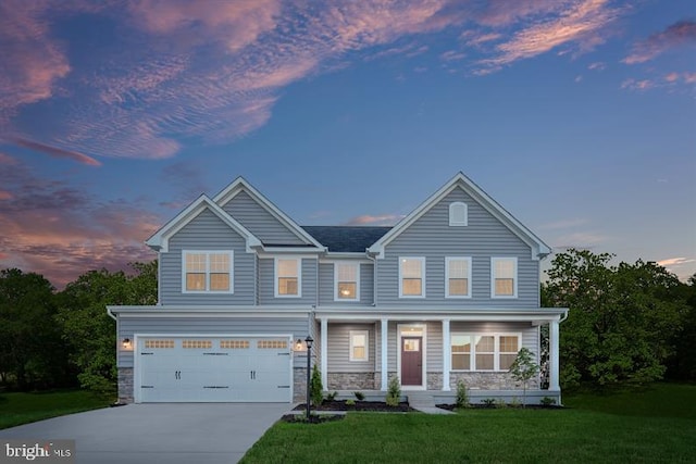 view of front of house with a yard and a garage