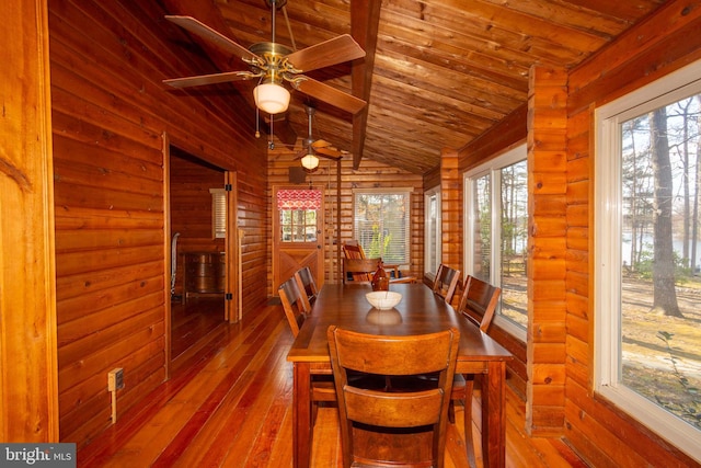 dining room with vaulted ceiling, light wood-type flooring, and wood ceiling