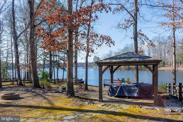 dock area featuring a gazebo, a water view, and an outdoor fire pit