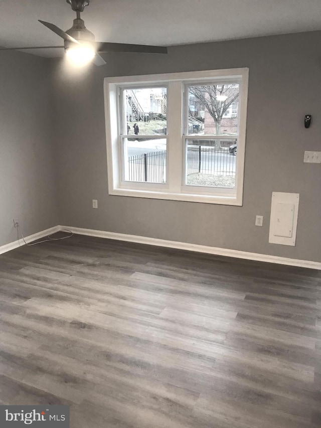 spare room with a ceiling fan, baseboards, and wood finished floors