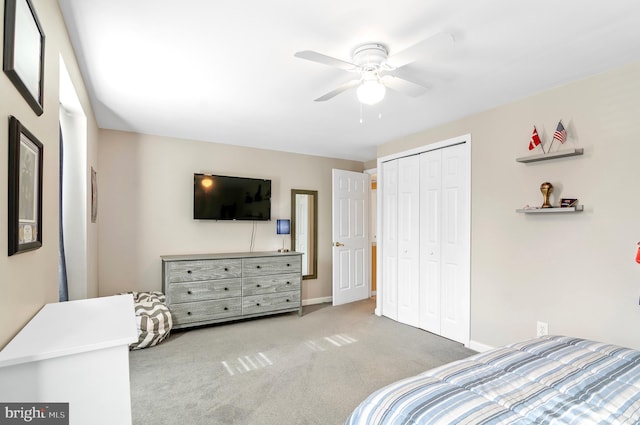 bedroom with ceiling fan, a closet, and carpet