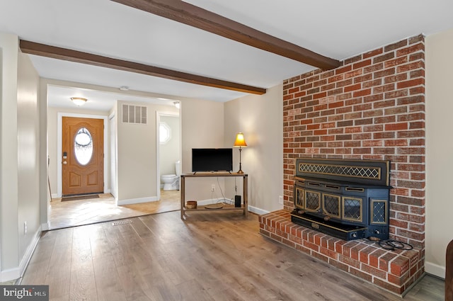 living room with beamed ceiling and wood-type flooring