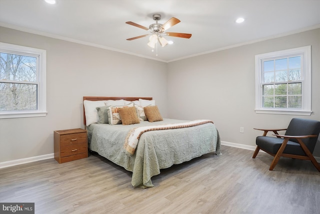 bedroom featuring crown molding, ceiling fan, and light hardwood / wood-style floors