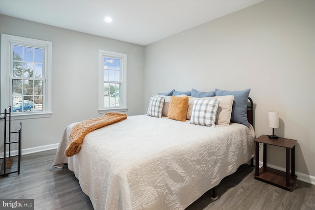 bedroom featuring dark hardwood / wood-style flooring and multiple windows