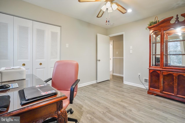 office space with ceiling fan and light hardwood / wood-style floors