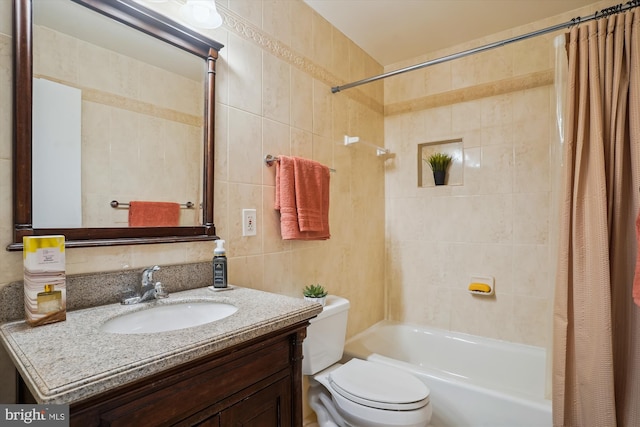 full bathroom featuring shower / bath combo, tile walls, vanity, and toilet