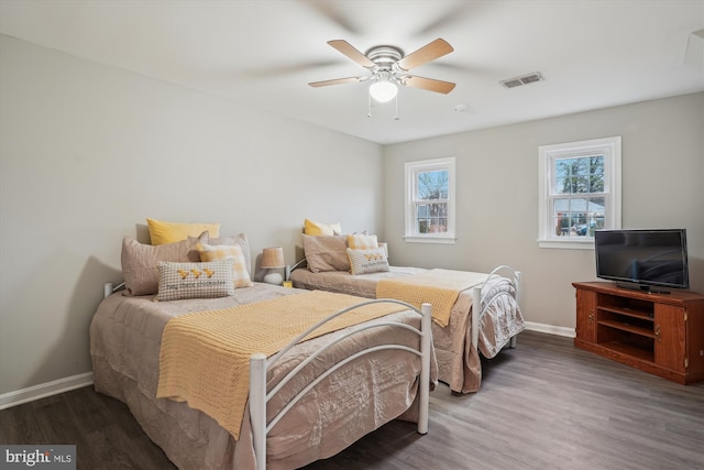 bedroom with ceiling fan and dark hardwood / wood-style flooring