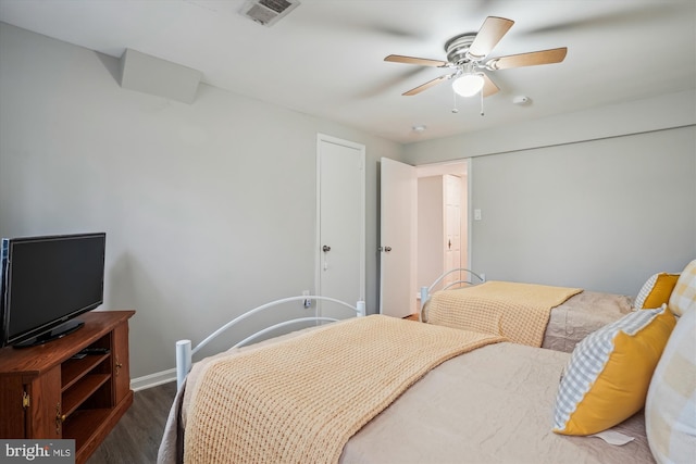 bedroom with dark wood-type flooring and ceiling fan