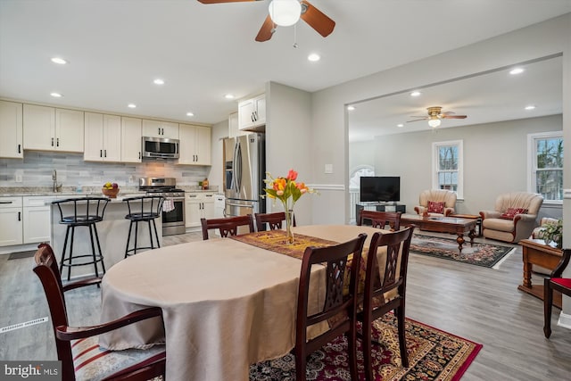 dining space with light hardwood / wood-style floors