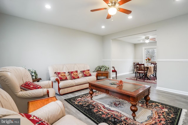 living room with hardwood / wood-style floors and ceiling fan