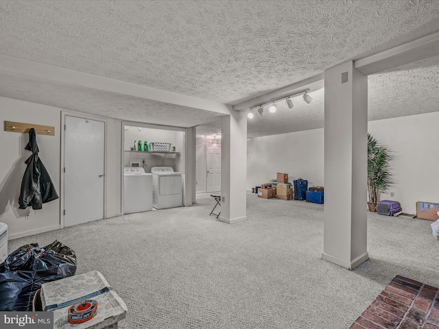 interior space with carpet flooring, a textured ceiling, and independent washer and dryer