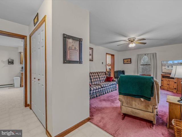 living room featuring a baseboard heating unit and ceiling fan