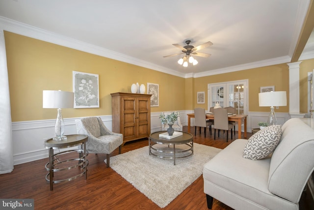 living room with dark wood-style floors, ceiling fan, ornate columns, and wainscoting