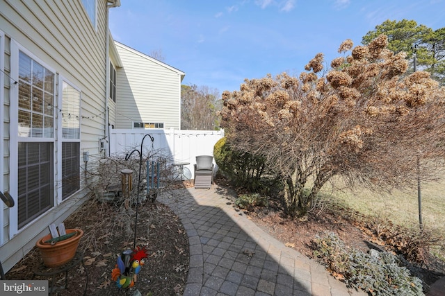 view of yard featuring fence and a patio