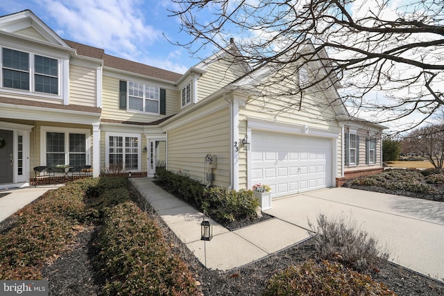 view of side of property with an attached garage and concrete driveway